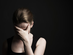 Young Woman With Face In Hands.